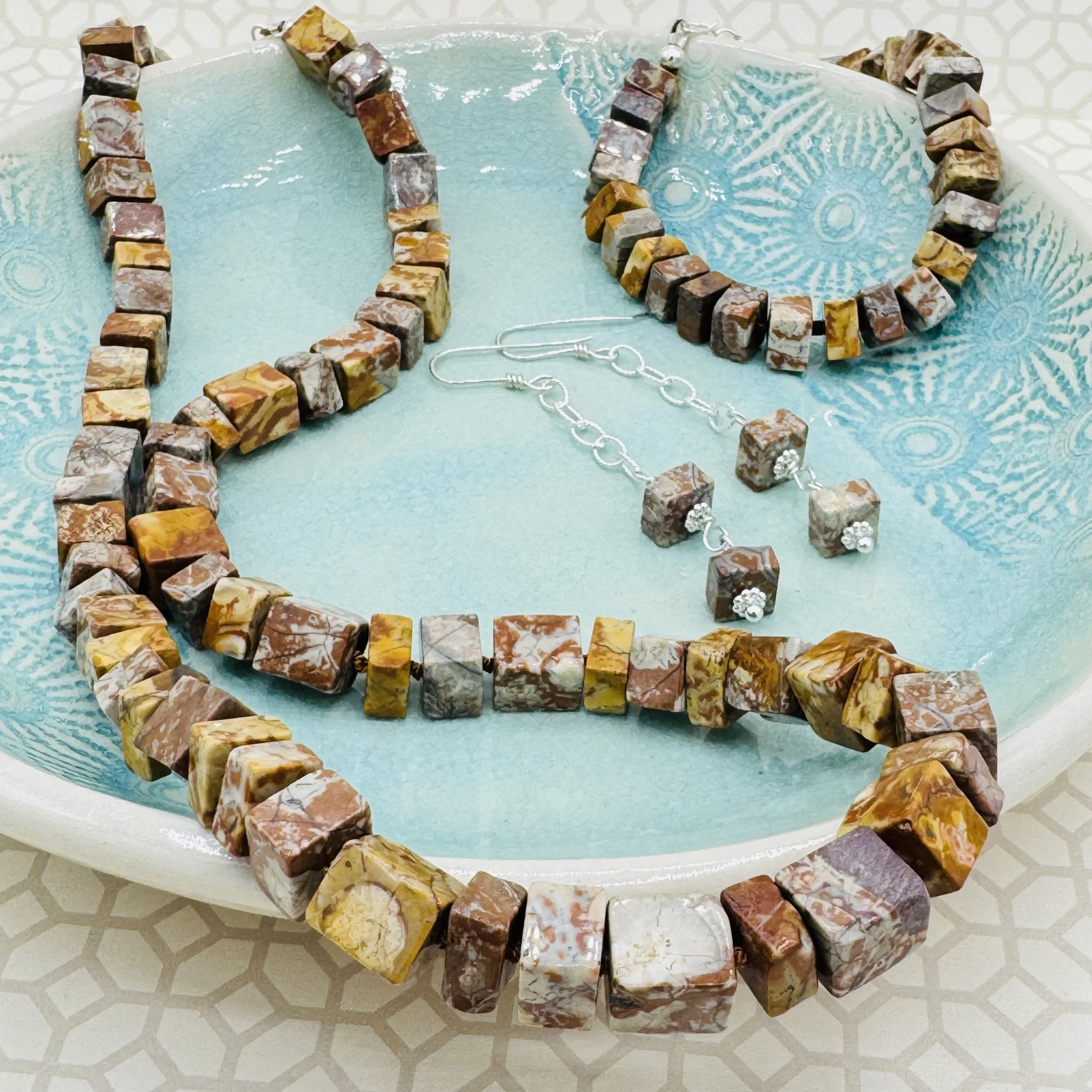 B JANECKA hand forged jewelry and free form pottery.